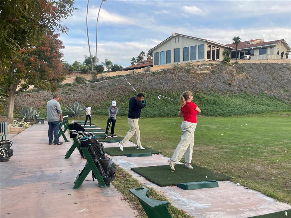 golfers taking swing