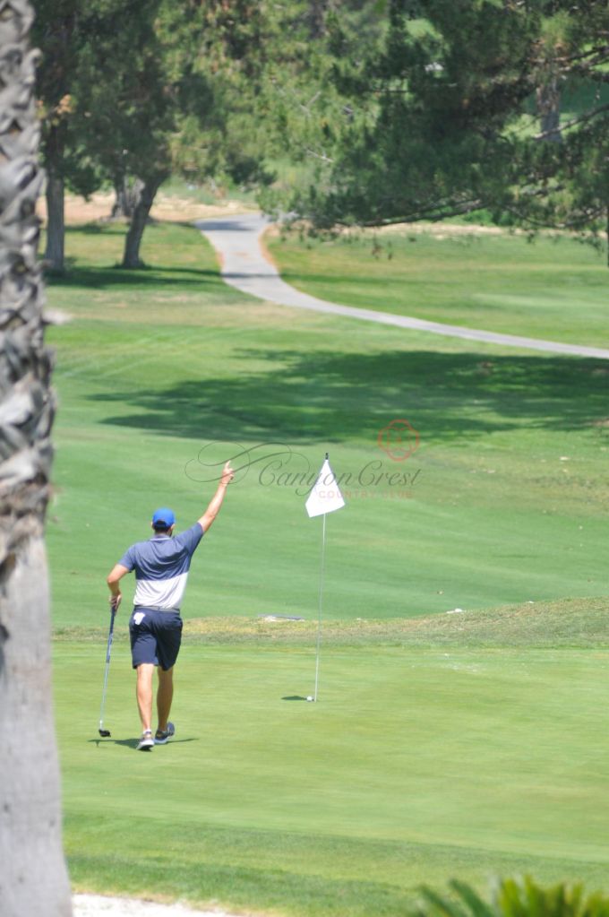 golfer near flag on golf course 