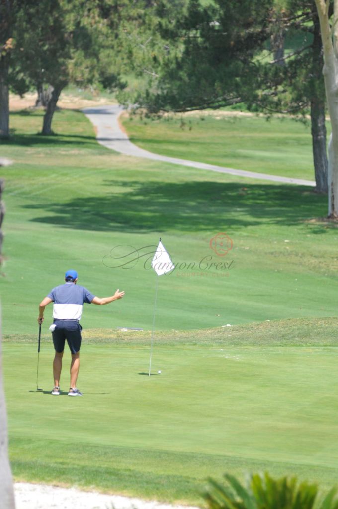 golfer after swing on golf course 