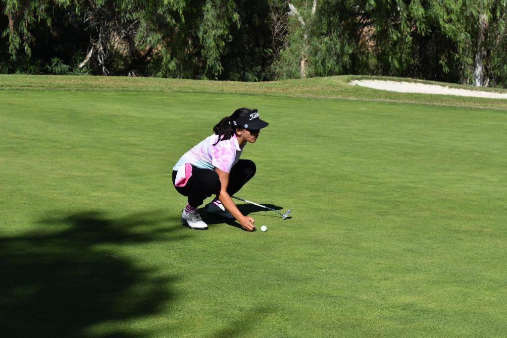 golfer setting up ball